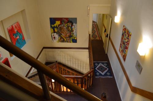 a view of a staircase with paintings on the wall at Hotel Gran Sarmiento in Buenos Aires