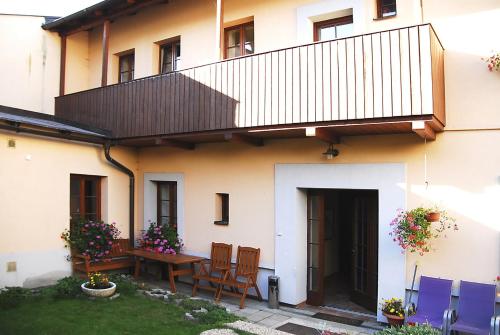 a house with a table and chairs in the yard at Apartmany A.Ša Kašperské Hory in Kašperské Hory