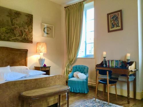 a bedroom with a bed and a desk and a window at AU TEMPS JADIS in Fumay