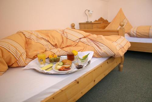 a tray of food is sitting on a bed at Landgasthof Stangl in Moosinning