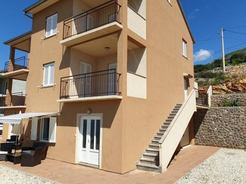 a large building with stairs and a balcony at Slavica apartments 2 in Sveti Juraj