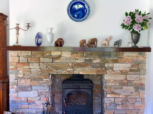 a brick fireplace with a stone fire place at Victoria's house in Kells