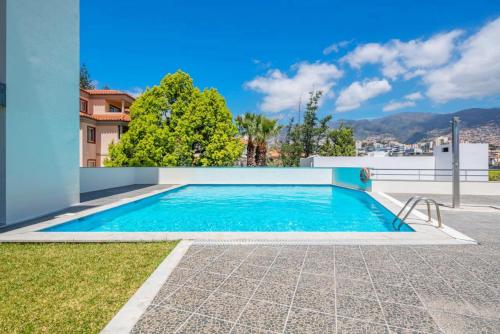 a swimming pool in the backyard of a house at Quinta Miramar in Funchal