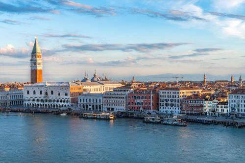 a city with a clock tower and a river at Hotel Paganelli in Venice