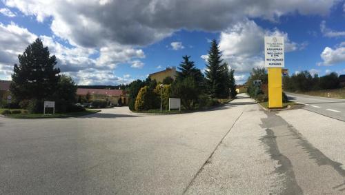 an empty street with a yellow sign in the middle at LIPNO WELLNESS - FRYMBURK C112 private family room in Frymburk
