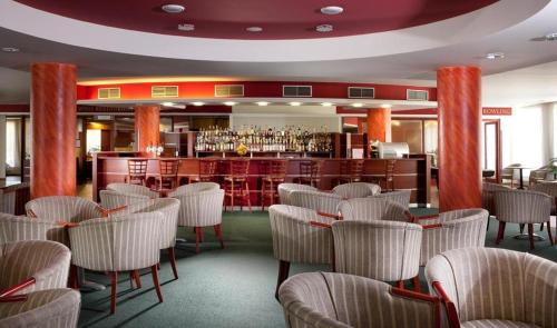 a restaurant with chairs and a bar in the background at LIPNO WELLNESS - FRYMBURK C112 private family room in Frymburk