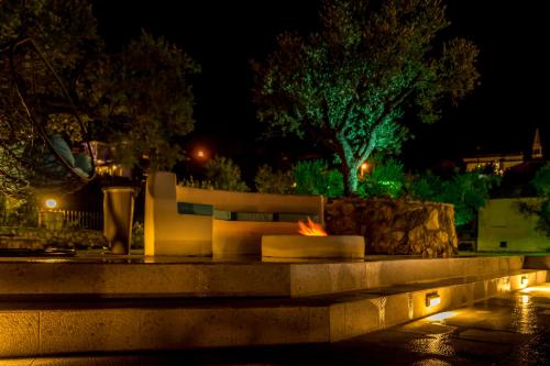 a bench sitting in a park at night at Villa Castelletto heated pool jacuzzi in Kipseli