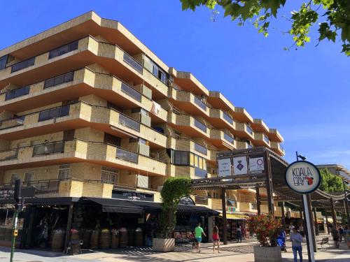 a large building with a clock on the side of it at Apartamentos Salou Centro in Salou
