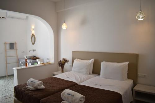 a bedroom with two beds with towels on them at Andriani's Guest House in Mýkonos City