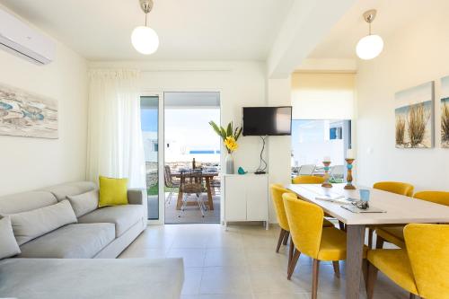 a living room with a couch and a table at Triton Sea View Villa in Georgioupolis