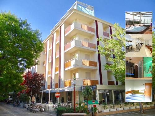 a large white building with balconies on a street at Hotel Aquila D'Oro in Misano Adriatico