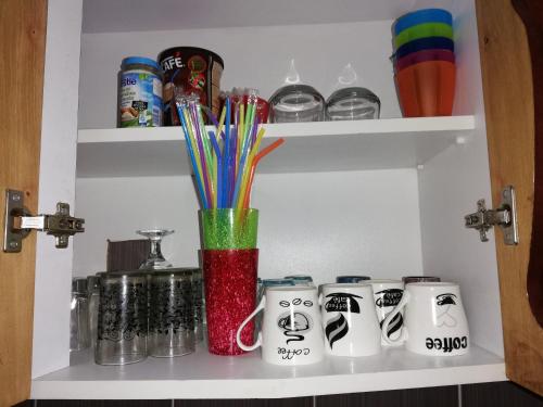 a shelf with a vase withcolored pens in it at Jednosoban stan centar in Pirot