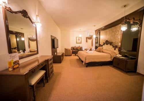 - une grande chambre avec un lit et un grand miroir dans l'établissement Hotel Marlon, à Chetumal