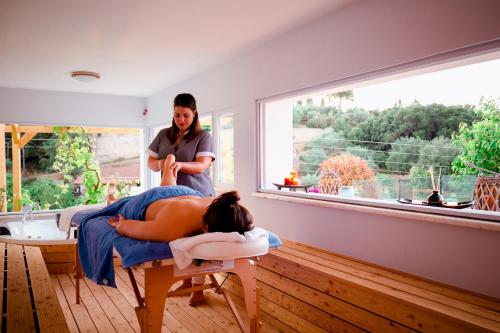 a woman getting a massage in a room at Villa Castelletto heated pool jacuzzi in Kypseli
