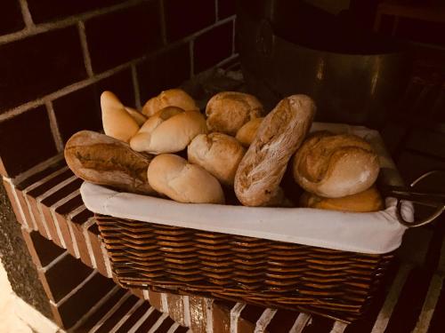 a basket of bagels and bread on a table at Hotel Portinari in Porto