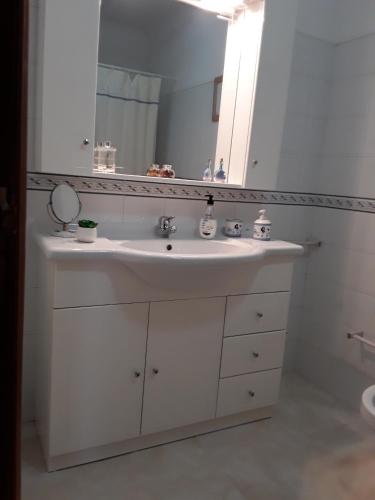 a bathroom with a white sink and a mirror at Villa Ciriaco Sea Star in Ericeira