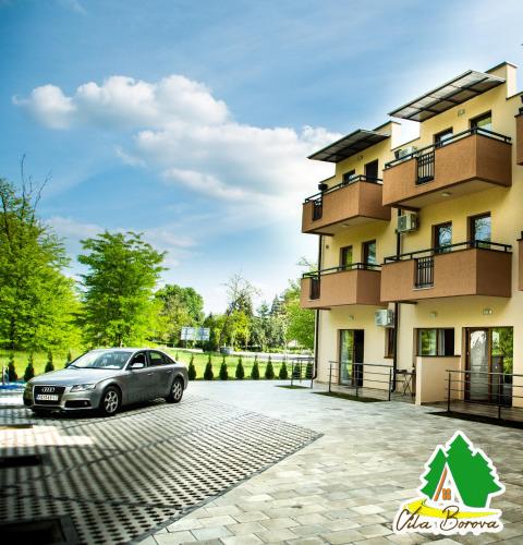 a car parked in front of a building at Apartmani borova 2 in Veliko Gradište