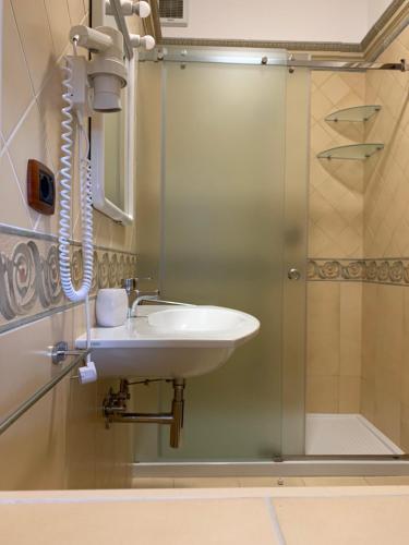 a bathroom with a sink and a shower at Villaggio Idra in Vieste