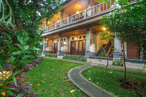 a building with a walkway in front of a yard at Adi Jaya Cottages Ubud Suites by EPS - CHSE Certified in Ubud