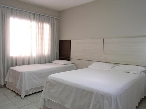 Ένα ή περισσότερα κρεβάτια σε δωμάτιο στο Hotel Curitiba Campo Comprido