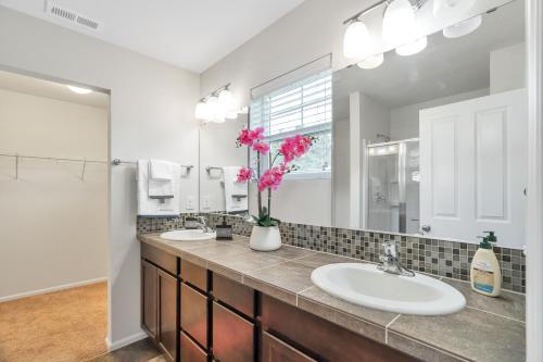 a bathroom with two sinks and a large mirror at Terra House Tacoma in Tacoma