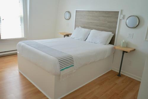 a bedroom with a large white bed with a wooden headboard at Inn on the Blues in York