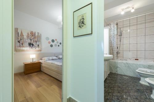a bathroom with a bed and a tub and a sink at Apartment Green Oasis in Dubrovnik