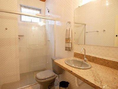 a bathroom with a sink and a toilet and a mirror at Alquimia House in Ouro Preto