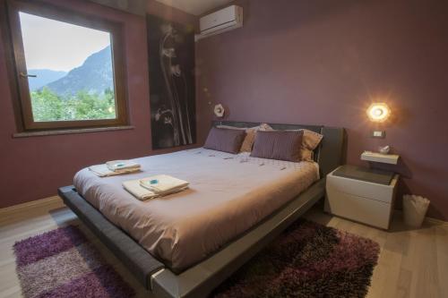 a bedroom with a large bed with a window at Affittacamere da Jasmina Venzone in Venzone