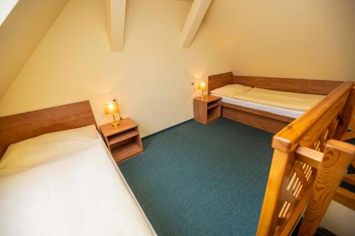 a room with two bunk beds and two lamps on tables at Pension KA.PR in Hluboká nad Vltavou