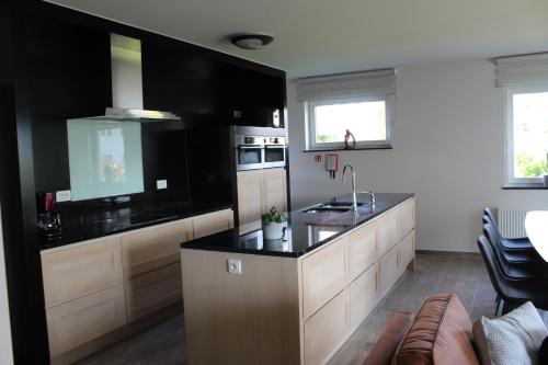 a kitchen with a large island with a counter top at Villa Appartement Amaryllis in Nieuwpoort