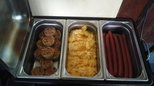 a tray with three trays of food in at Pension KA.PR in Hluboká nad Vltavou