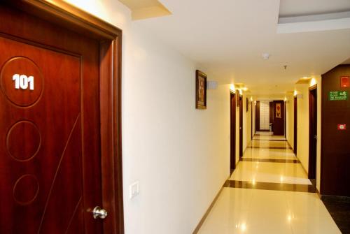 a corridor of a hotel with a door and a hallway at Hotel Orbit in Chandīgarh