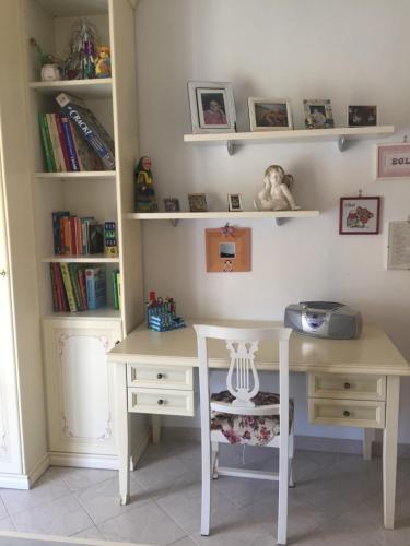 a desk and a table and a book shelf at Da Monica in Canneto