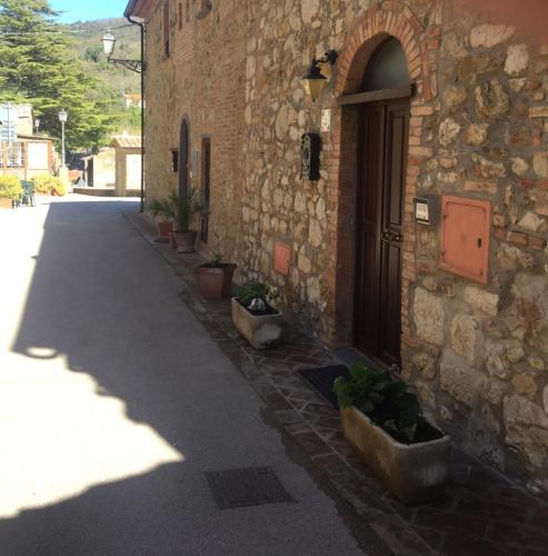 a building with potted plants on the side of a street at Da Monica in Canneto