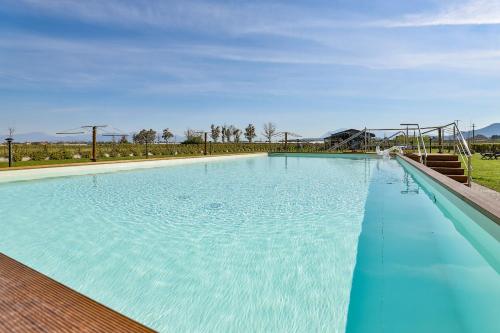 a large blue swimming pool with a roller coaster at I giardini dell'Olimpo in Paestum