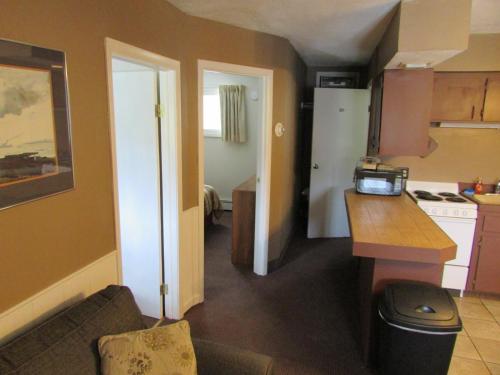 a small kitchen with a sink and a counter in a room at The Lake George Inn in Lake George