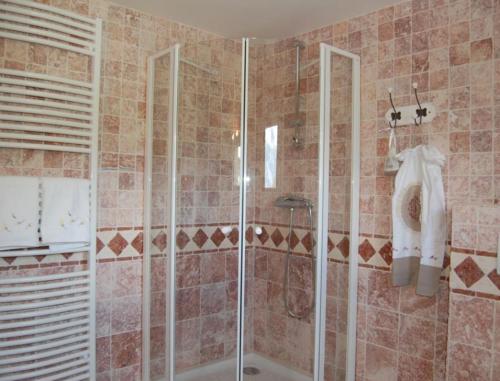 a shower with a glass door in a bathroom at La Charlisa in Pra-Loup