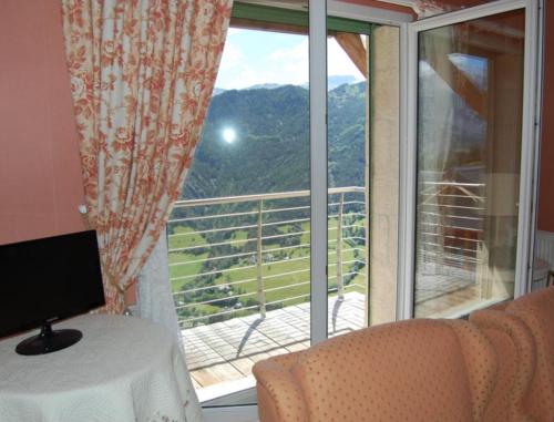 a room with a window with a view of a mountain at La Charlisa in Pra-Loup