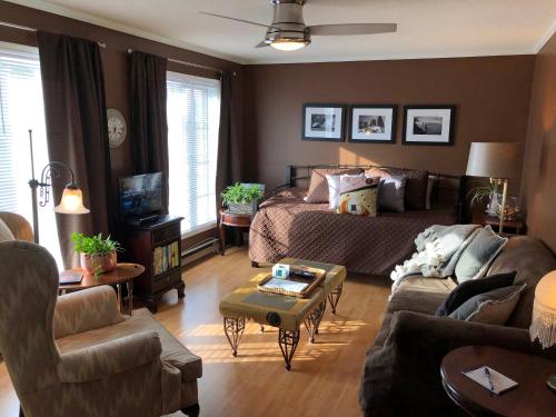 a living room with a bed and a couch at Butler Creek House in Niagara on the Lake