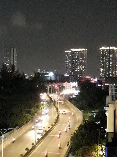 a city street at night with cars on the road at La Galerie Hotel in Ho Chi Minh City