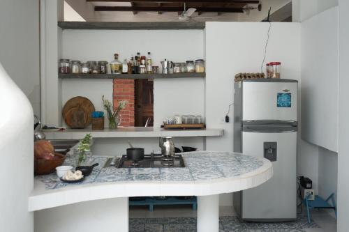 a kitchen with a sink and a refrigerator at Casa Caracola in Tubará