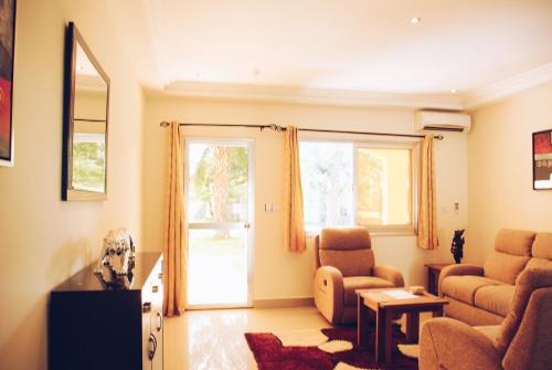 a living room with a couch and a chair at Kololi Beach Resort in Kololi