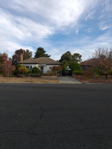 an empty street in front of a house at Happy Home in Bendigo