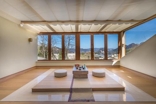 a living room with a large window and a table at Evergreen Retreat-walk to National Forest Park, free pick up service in Zhangjiajie