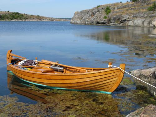a wooden boat in the water on a lake at Stenslid Bottna By St Anna in Söderköping