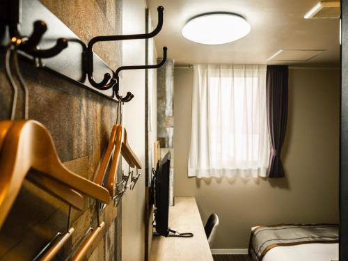 Postel nebo postele na pokoji v ubytování Hotel Areaone Kitaibaraki