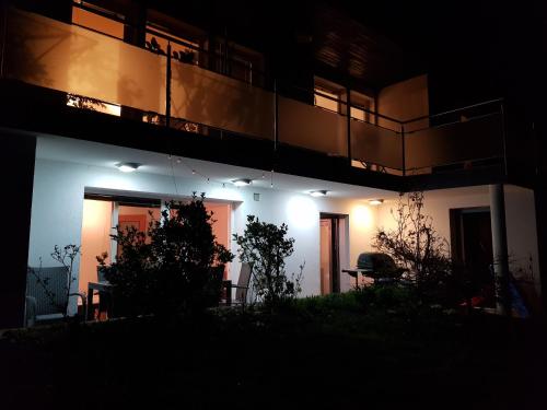 a night view of a building with a balcony at Apartment Dolce Vita in Celje