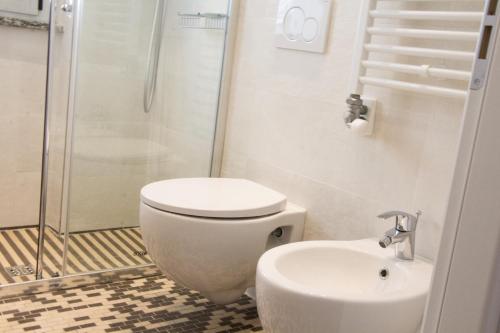 a bathroom with a toilet and a shower and a sink at Family Suite Appartments Orchidea Blu in Rimini