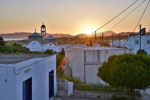 a sunset over a city with a mosque in the background at Avra Milos in Zefiría